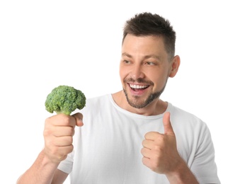 Portrait of happy man with broccoli on white background