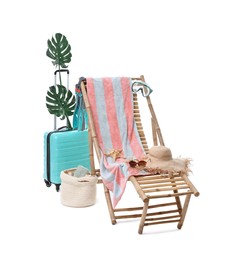 Photo of Deck chair, suitcase and beach accessories isolated on white