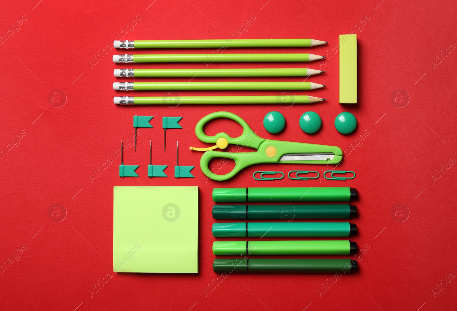 Photo of Flat lay composition with stationery on red background