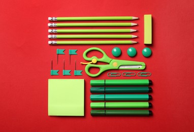 Photo of Flat lay composition with stationery on red background