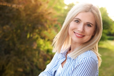 Photo of Portrait of beautiful woman outdoors on sunny day, space for text