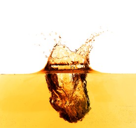 Golden oily liquid splash on white background