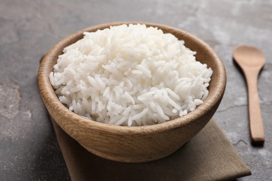 Bowl of tasty cooked rice served on table