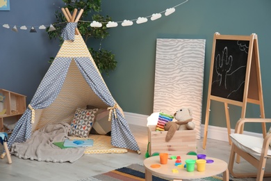 Photo of Modern room interior with play tent for child