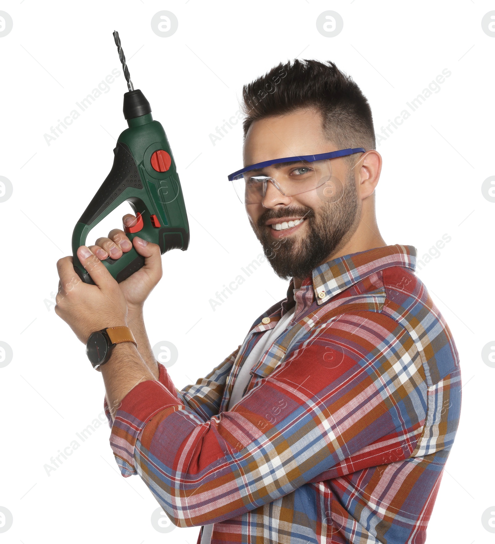 Photo of Young man in protective goggles with power drill on white background