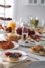 Photo of Variety of snacks on white marble table in buffet style indoors