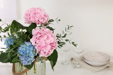 Photo of Beautiful hortensia flowers in kitchen. Space for text