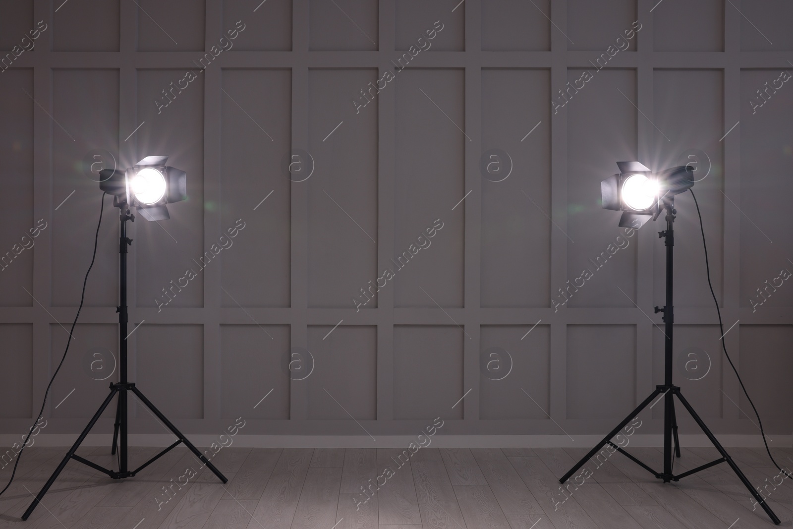 Photo of Bright white spotlights near wall indoors, space for text