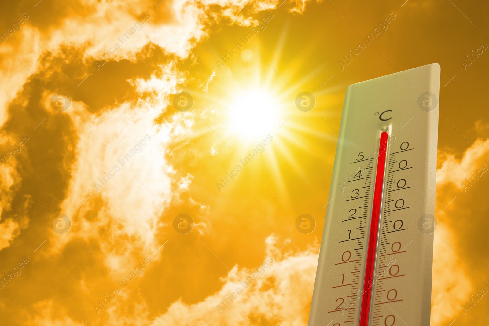 Image of Thermometer showing high temperature against sky with clouds during very hot day in summer