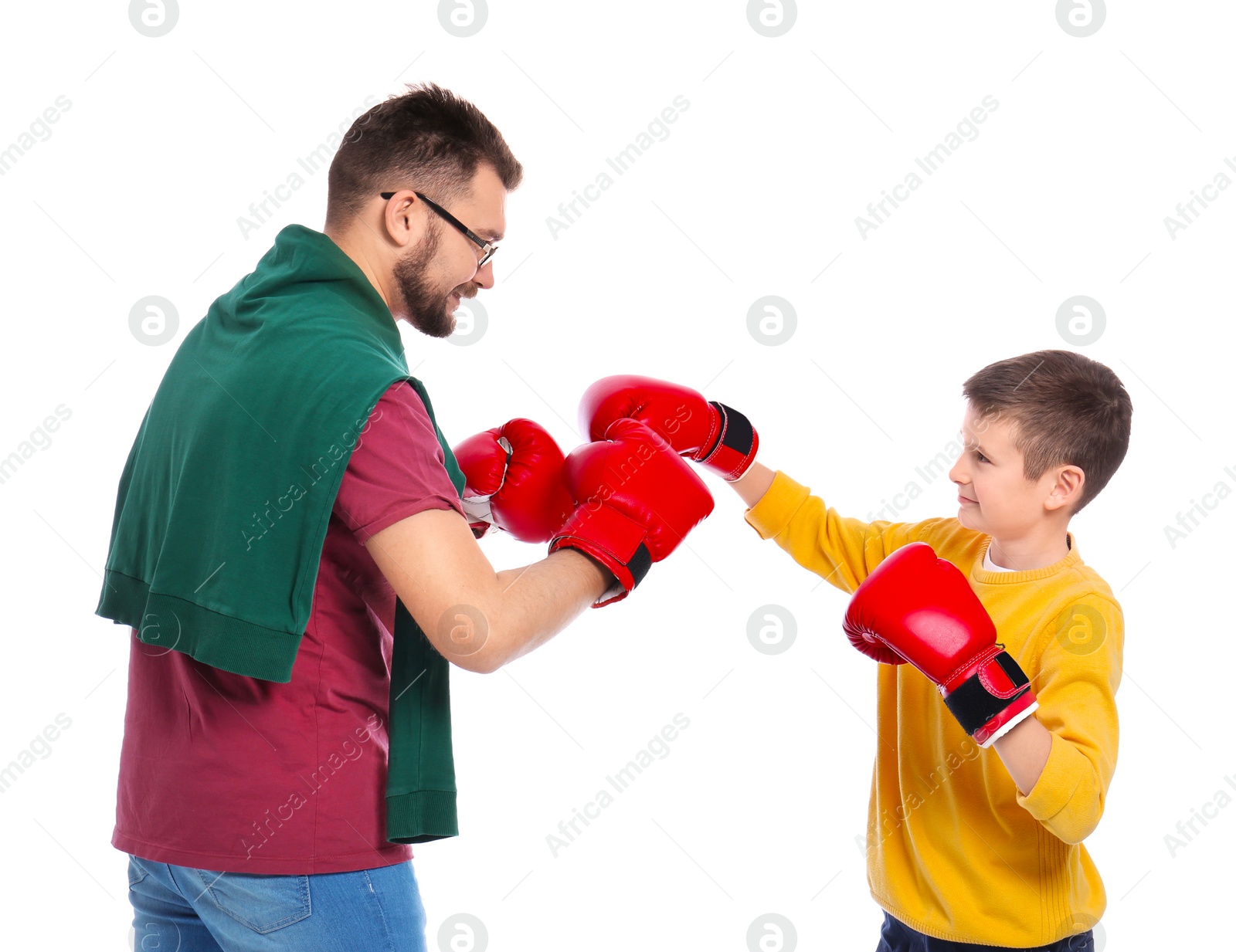 Photo of Little boy and his dad in boxing gloves on white background