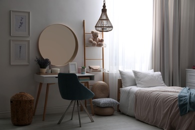 Photo of Teenage girl's bedroom interior with stylish furniture. Idea for design