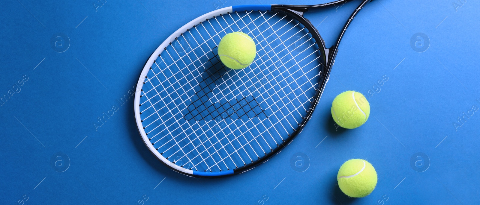 Image of Tennis racket and balls on blue background, flat lay. Banner design