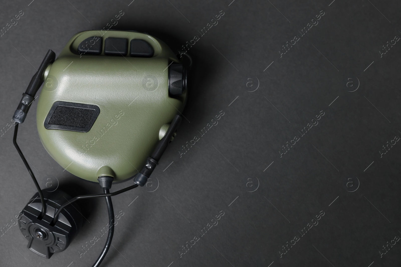 Photo of Tactical headphone on black background, top view with space for text. Military training equipment