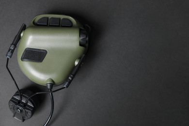 Photo of Tactical headphone on black background, top view with space for text. Military training equipment