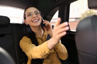 Photo of Woman with seatbelt talking on phone inside car