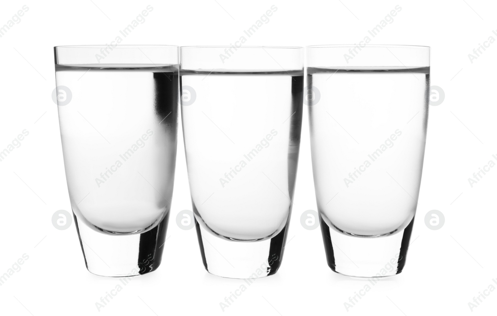 Photo of Cold vodka in shot glasses on white background