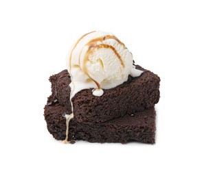 Photo of Tasty brownies with ice cream and caramel sauce isolated on white