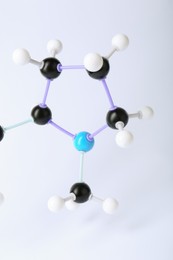 Photo of Molecule of nicotine on white background, closeup. Chemical model