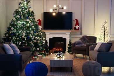 Photo of Cozy living room interior with beautiful Christmas tree near fireplace