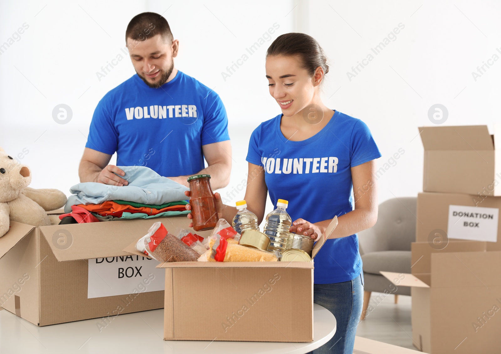 Photo of Young volunteers collecting donations at table indoors