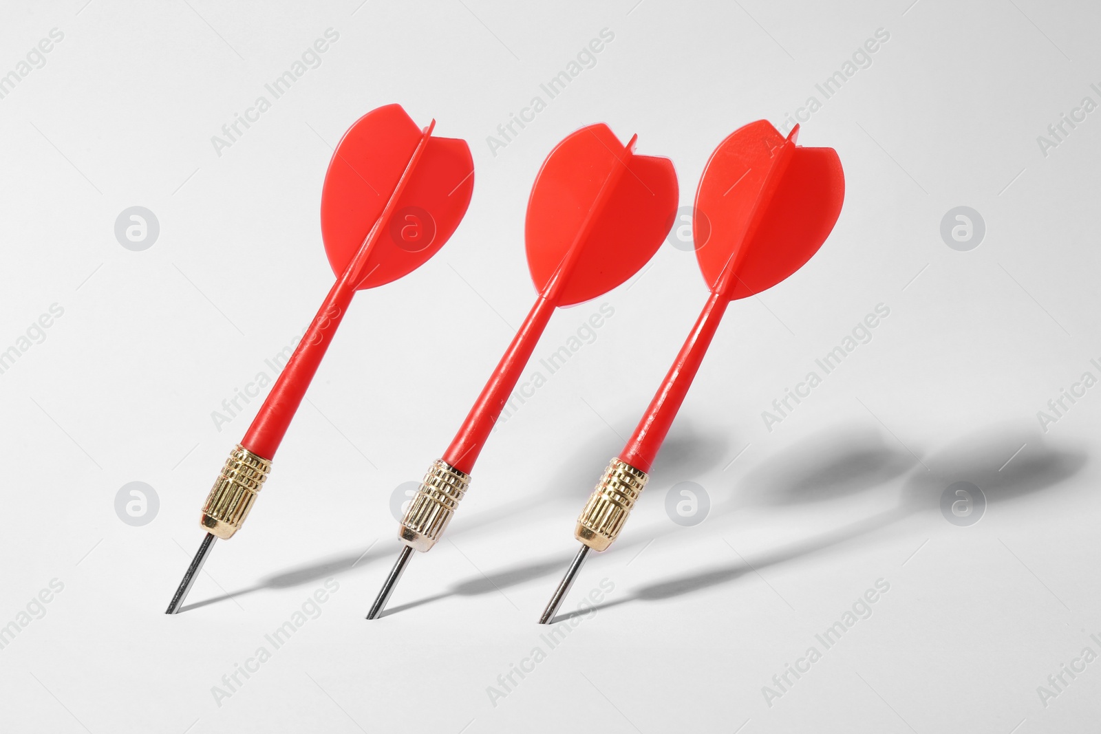 Photo of Red dart arrows for game on white background