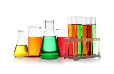 Photo of Set of different lab glassware with color liquid isolated on white