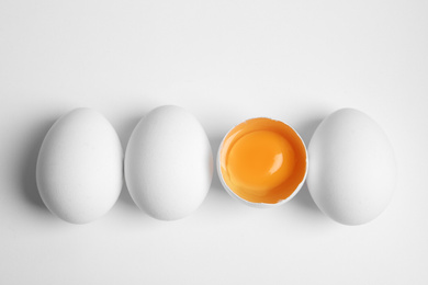 Photo of Fresh raw chicken eggs on white background, flat lay