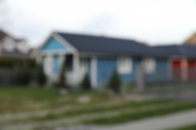 Blurred view of beautiful light blue house outdoors. Real estate