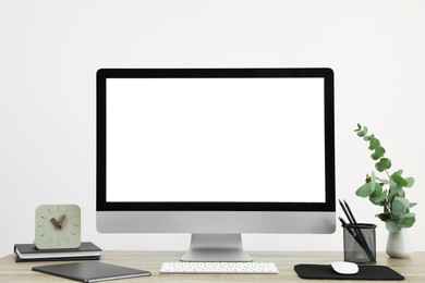 Photo of Modern computer with blank screen on desk, space for design. Comfortable workplace