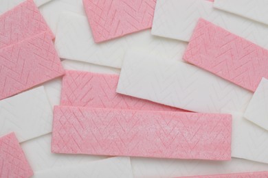 Photo of Sticks of tasty chewing gum as background, top view