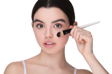 Teenage girl with makeup brush on white background