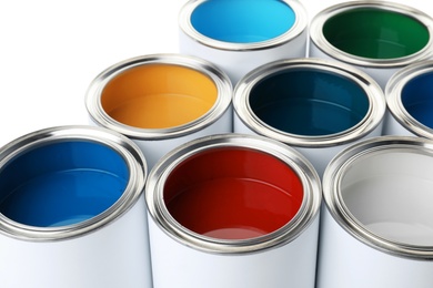 Photo of Open paint cans on white background, closeup