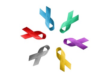 Image of Set with different color ribbons on white background, top view. World Cancer Day
