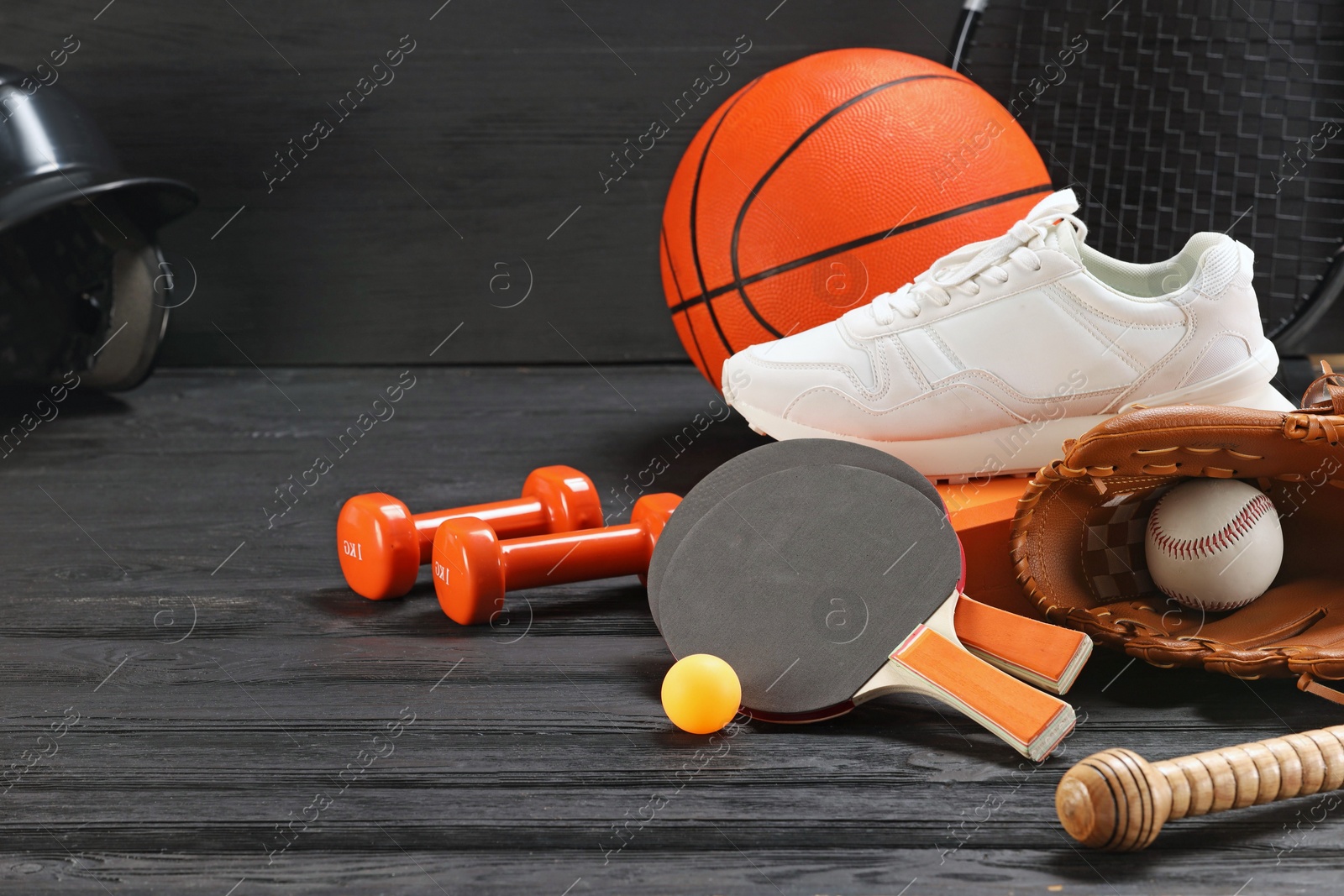 Photo of Many different sports equipment on dark grey wooden table