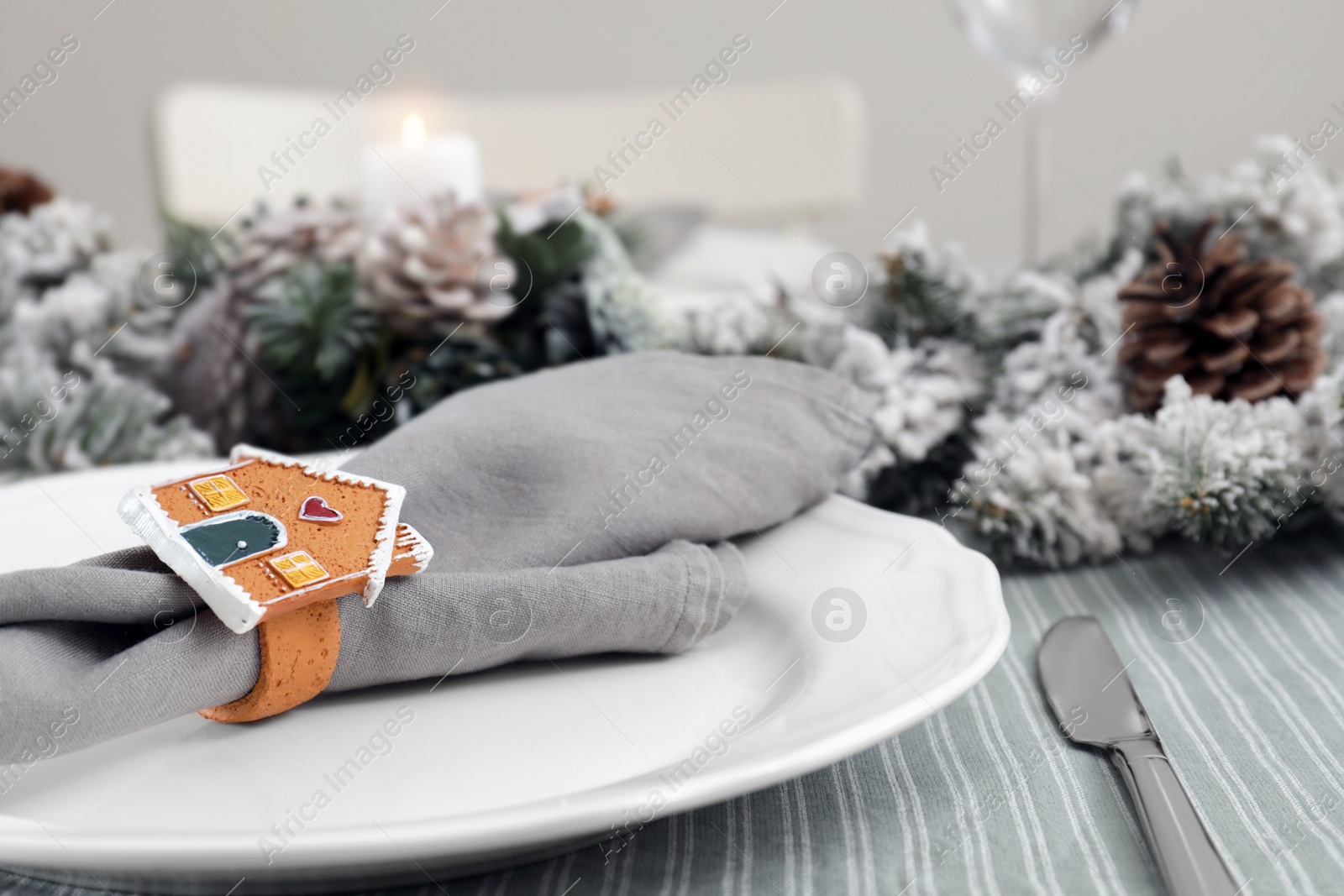 Photo of Festive place setting with beautiful dishware and decor for Christmas dinner, closeup