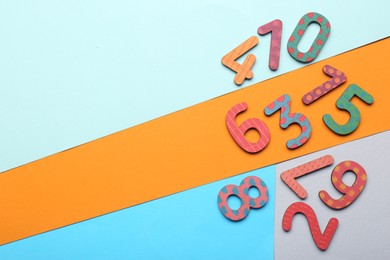 Photo of Wooden numbers on colorful background, flat lay. Space for text