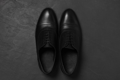 Photo of Pair of leather men shoes on grey surface, top view