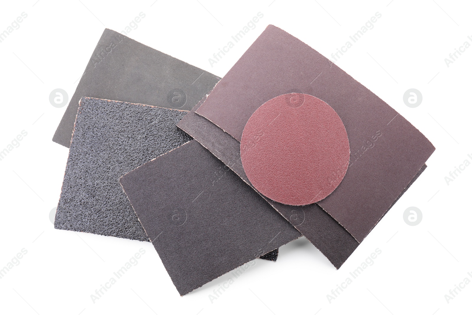 Photo of Many sheets of sandpaper isolated on white, top view