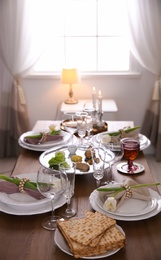 Photo of Festive Passover table setting at home. Pesach celebration