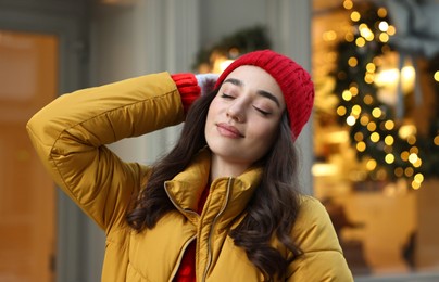 Photo of Portrait of beautiful woman on city street in winter