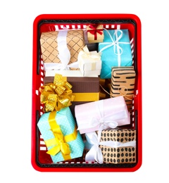 Photo of Shopping basket full of gift boxes on white background, top view