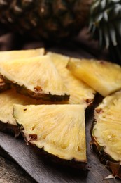 Pieces of tasty ripe pineapple on table, closeup