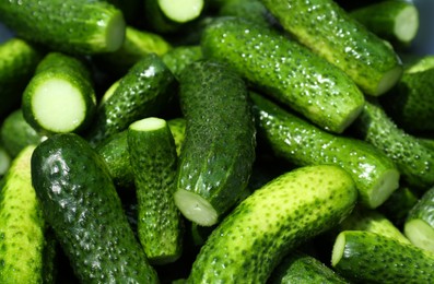 Photo of Many fresh ripe cucumbers as background, closeup