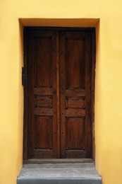 Photo of View of building with wooden door. Exterior design