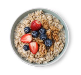 Photo of Tasty oatmeal with strawberries, blueberries and walnuts in bowl isolated on white, top view