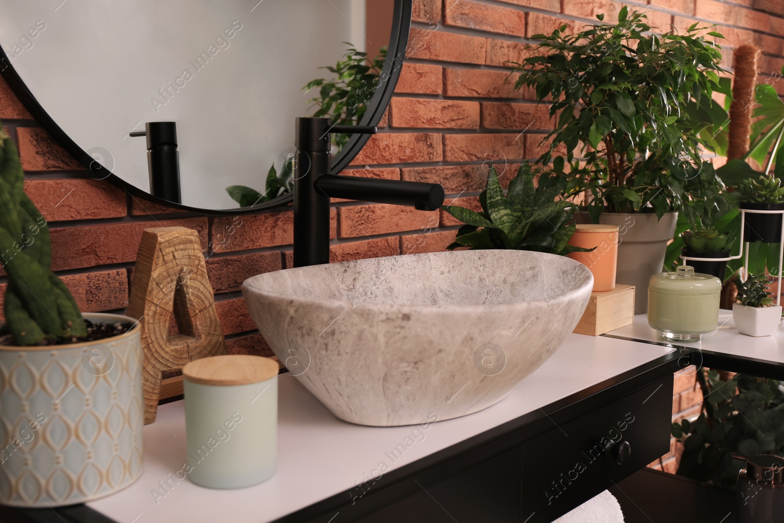 Photo of Stylish sink and beautiful green houseplants in bathroom. Interior design