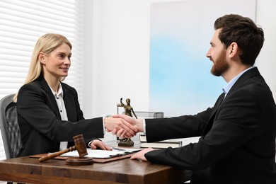 Photo of Lawyer shaking hands with client in office
