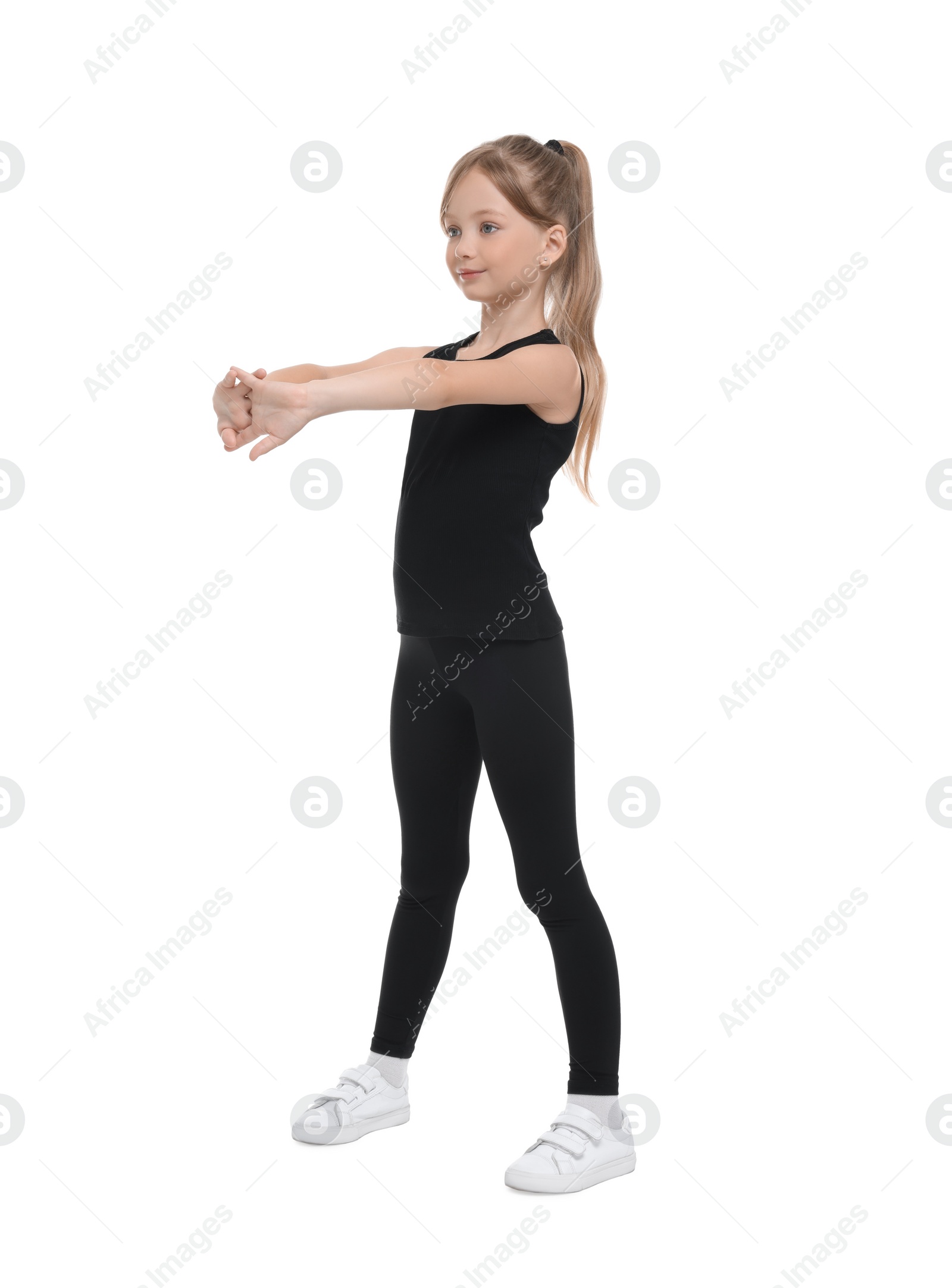 Photo of Little girl doing morning exercise on white background