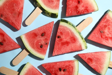 Photo of Slices of ripe watermelon on light blue background, flat lay