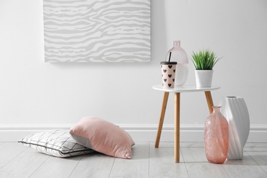 Photo of Beautiful room interior with vases and decorative pillows